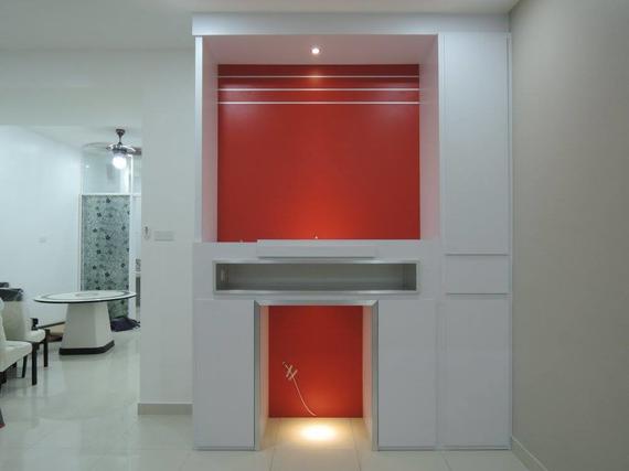 White built-in wall unit with a red alcove, recessed lighting, and a small shelf.