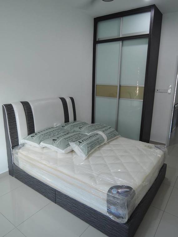 Bedroom with bed, pillows, and a sliding door wardrobe.