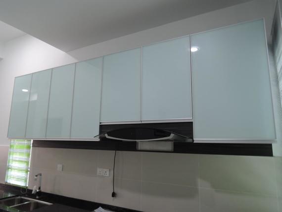 White kitchen cabinets above a black range hood and backsplash.