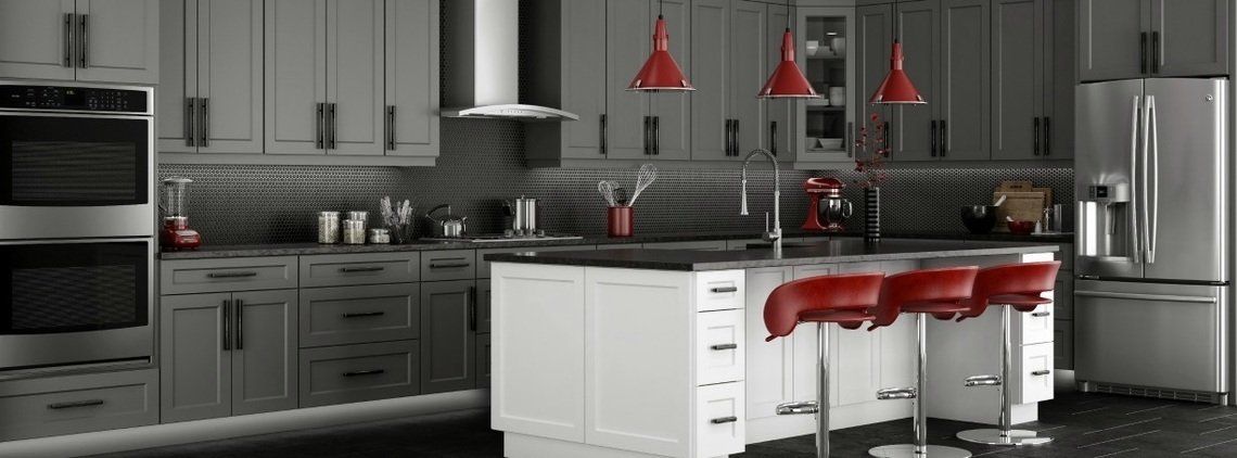 Modern kitchen with gray cabinets, red pendant lights, and a white island with red bar stools.