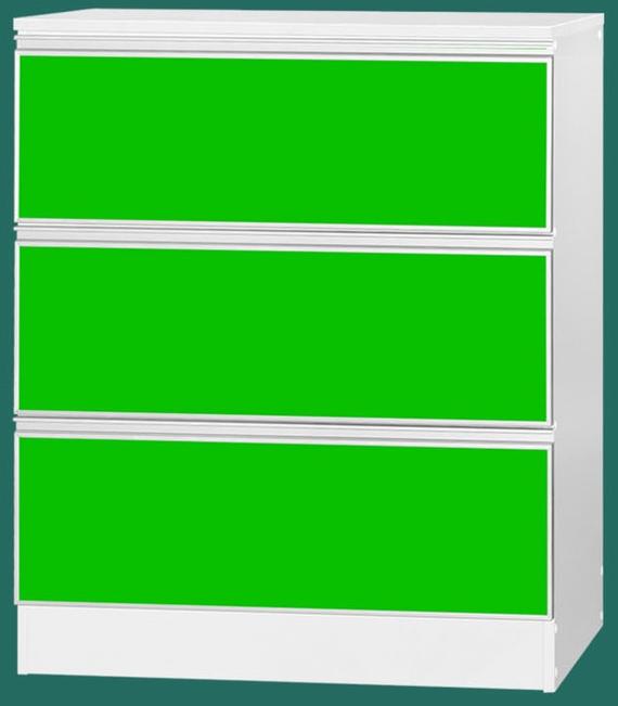 White dresser with three green drawers.