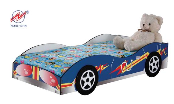 A child's bed in the shape of a blue race car, with a teddy bear sitting on the bed.