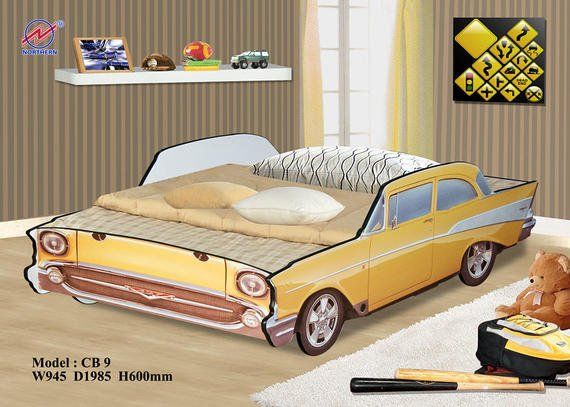 Yellow car-shaped bed in a child's room, with pillows, teddy bear, toys, and decor on the wall.