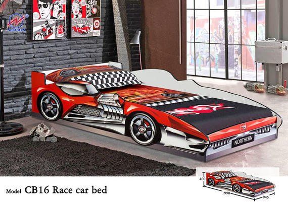 Race car bed in a child's room, red and white design.