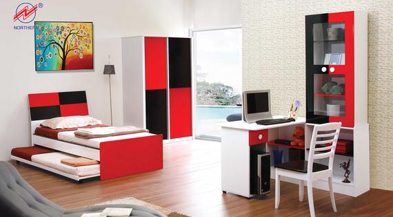 Red, black, and white bedroom furniture set with a bed, desk, wardrobe, and bookcase against a light wall.