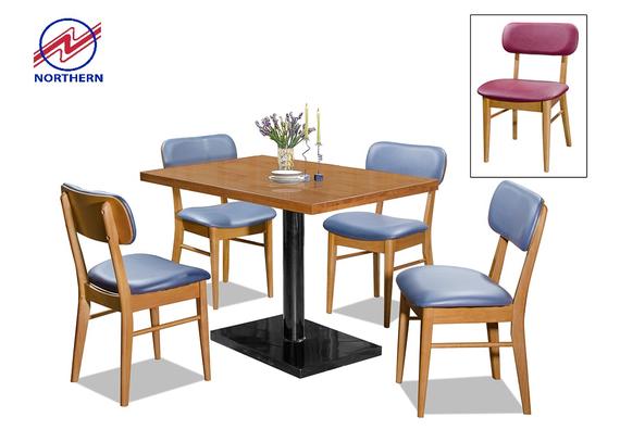 Dining table with four blue-seated chairs and a wood-look top; inset, a single pink-seated chair.