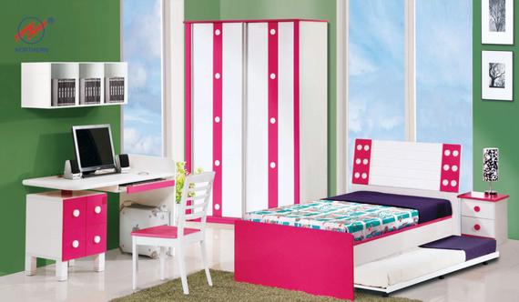 Pink and white bedroom set for a girl: bed, desk, wardrobe, nightstand, green wall, and chair.