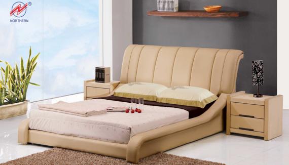 Beige modern bed with matching nightstands in a well-lit room.