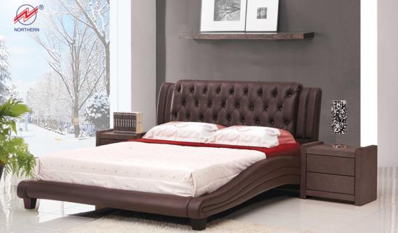 Brown leather bed in a modern bedroom with nightstands and a snowy landscape view.