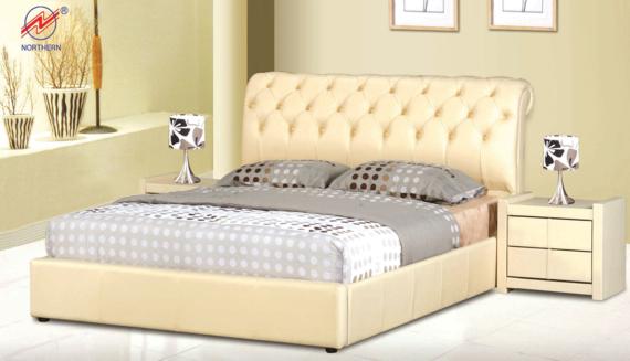Beige upholstered bed with tufted headboard, bedside table, lamps, and neutral-toned bedding.