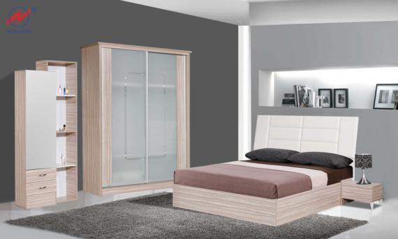 Bedroom furniture set in neutral tones with bed, wardrobe, bookcase, and nightstand on a gray carpet.