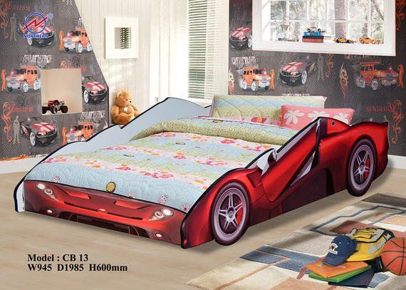 Red car-shaped bed in a child's room with car wallpaper.