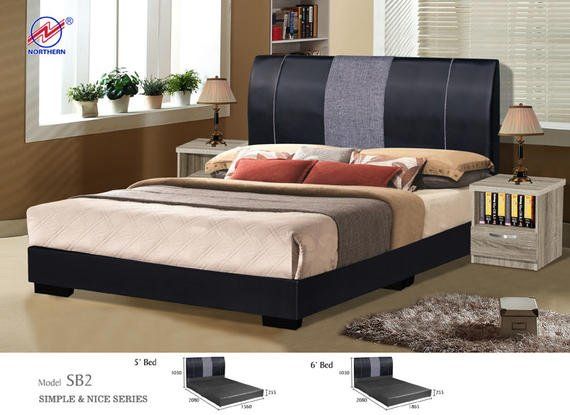 Black bed with gray headboard, two nightstands, and decor in a bedroom.