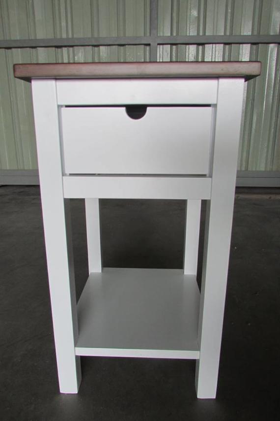 White and brown nightstand with a drawer and shelf.