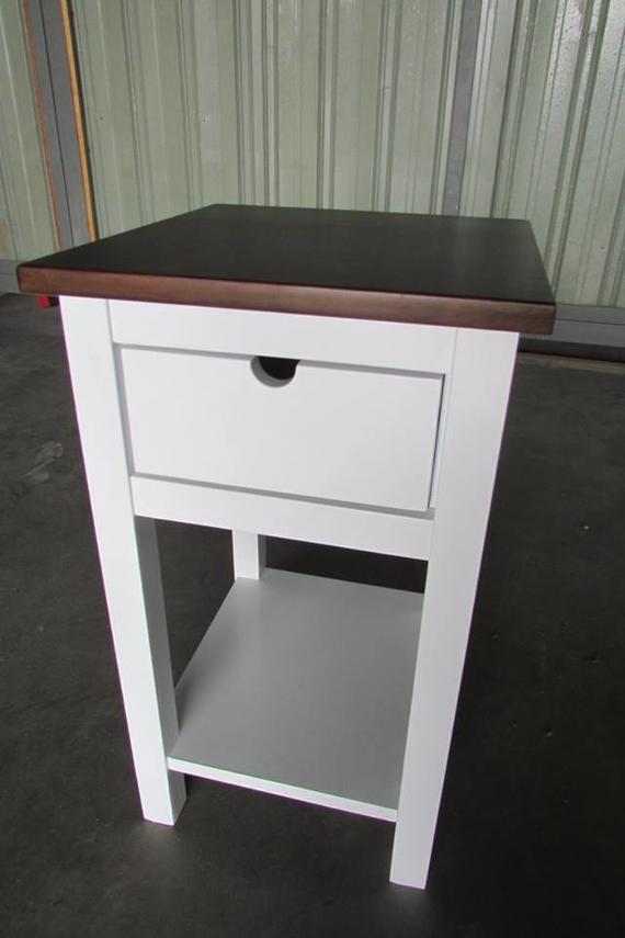 White nightstand with a dark brown top and a single drawer, and an open bottom shelf.