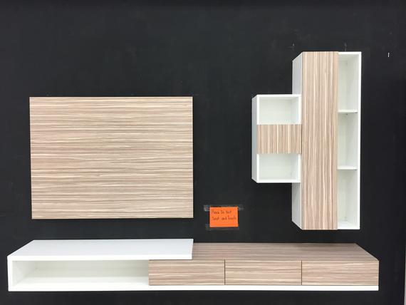 Modern wall-mounted media center with wood-grain and white shelving against a black background.