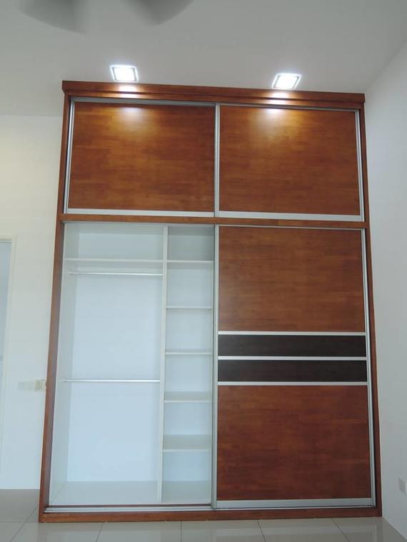 Wooden sliding door closet with open and closed sections; lights above.