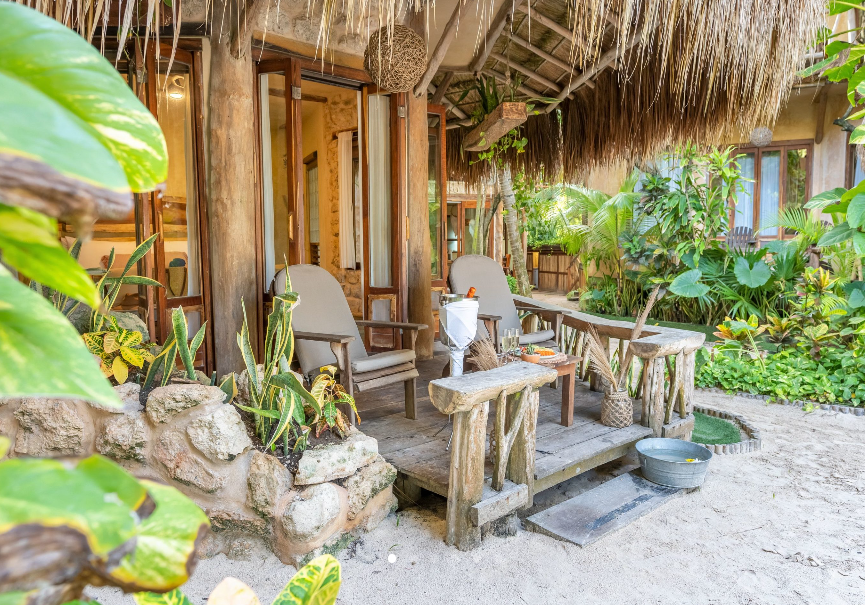 The sun is shining through the clouds over a field of flowers.