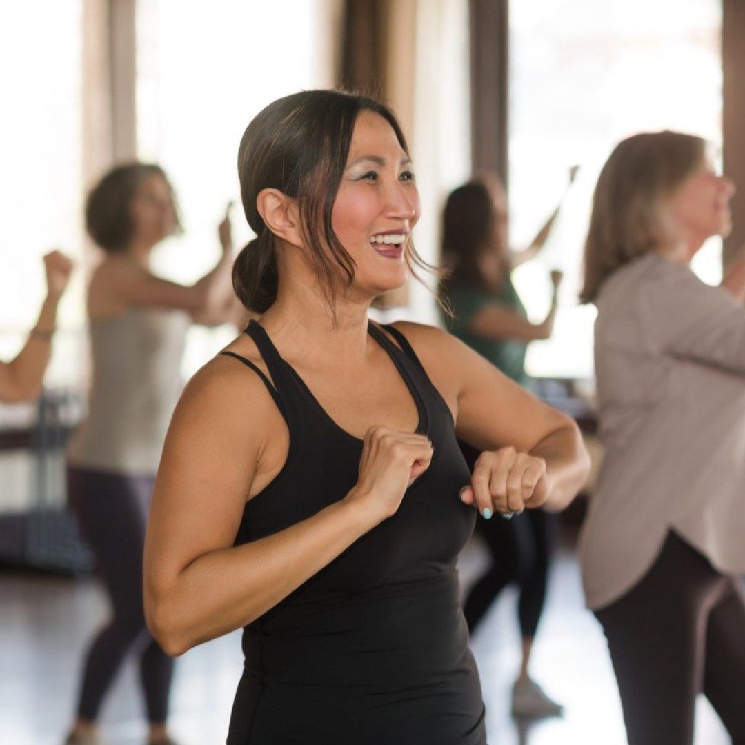 A man and a woman are dancing tango on a wooden floor.