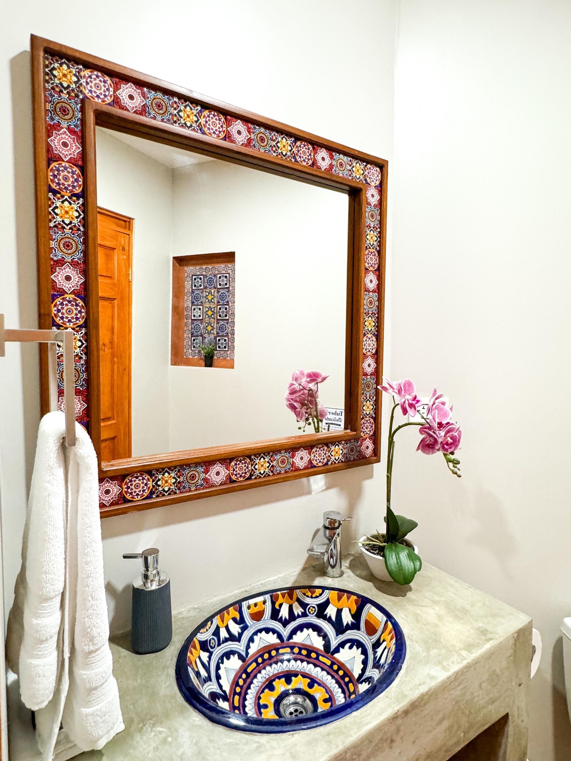 A bathroom with a large mirror and a sink.