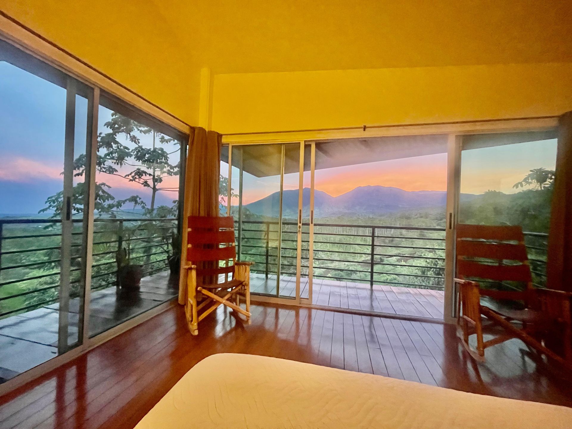 A bedroom with a sliding glass door leading to a balcony