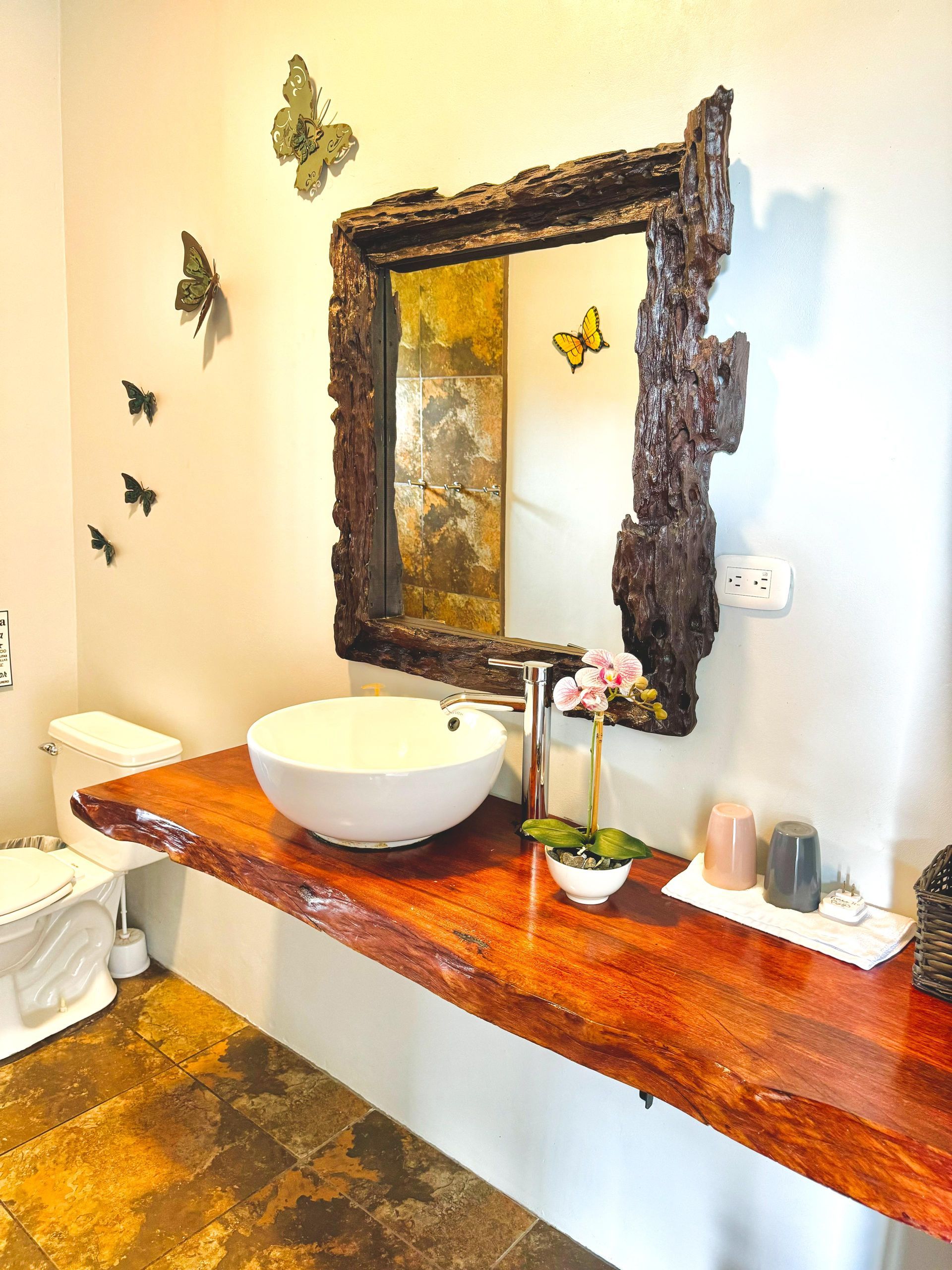 A bathroom with a sink , toilet and mirror
