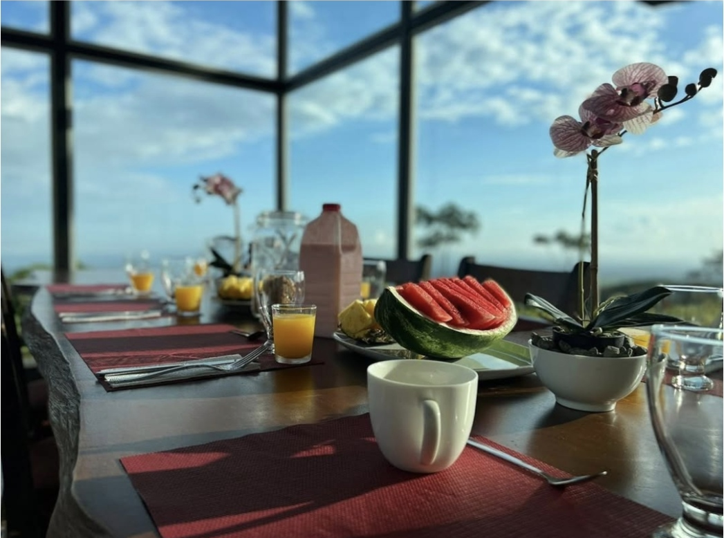 A table with a watermelon and a cup of coffee on it