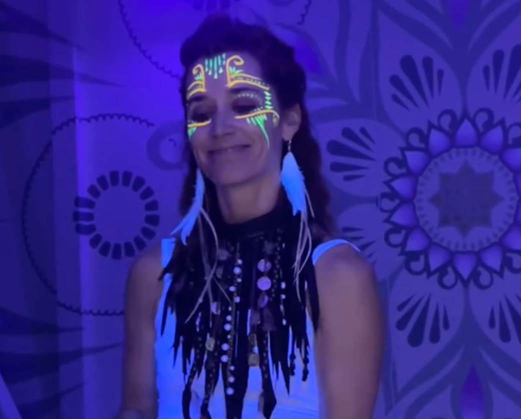 A woman with glow in the dark paint on her face