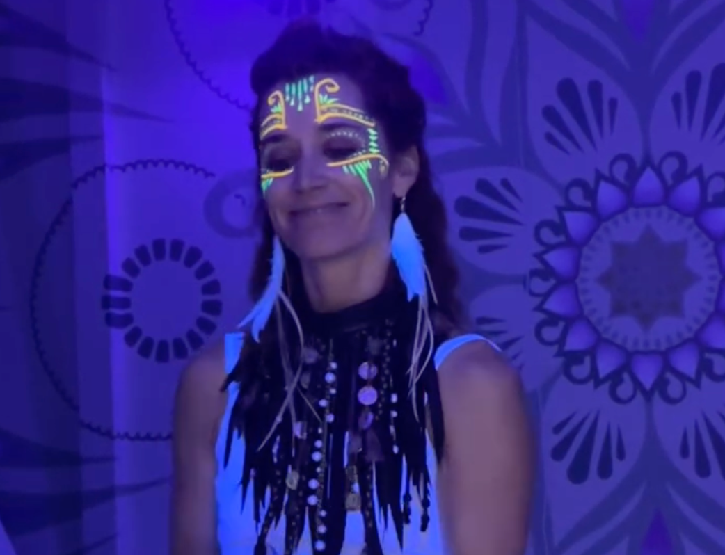 A woman with glow in the dark paint on her face