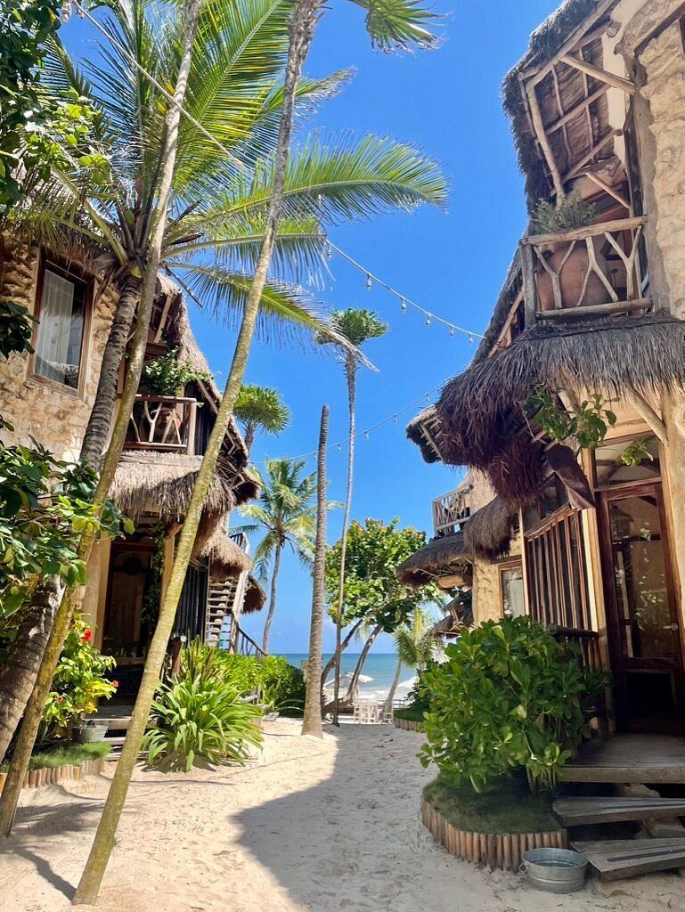woman in a yoga pose on a balcony overlooking the Costa Rican jungle landscape