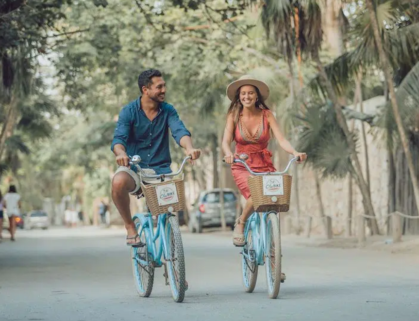 Two rocking chairs are sitting on a balcony overlooking mountains