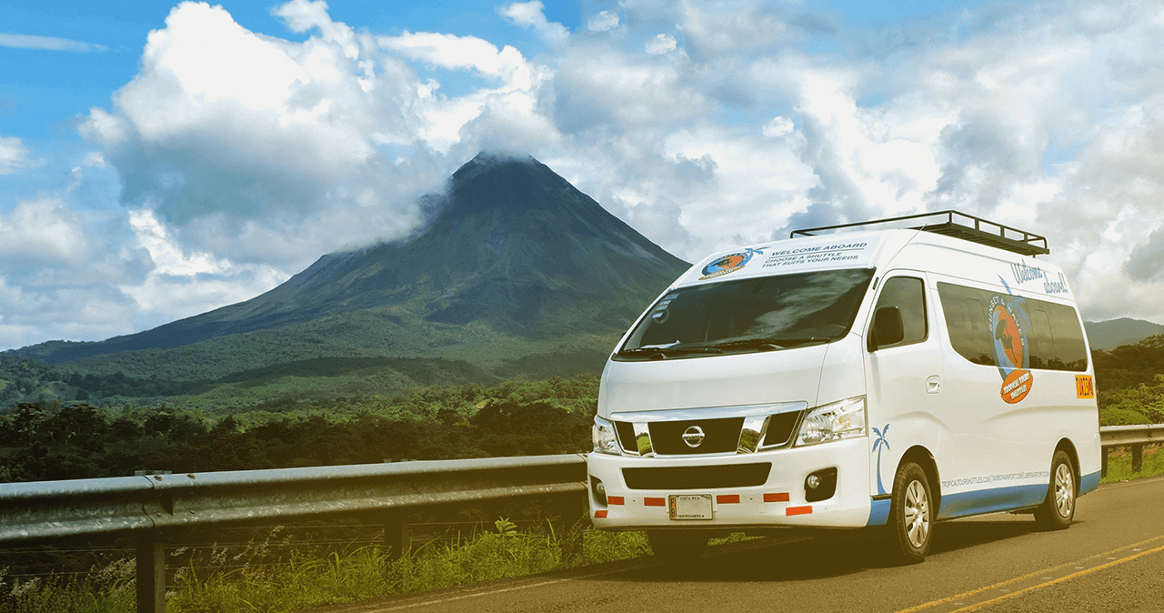 Two rocking chairs are sitting on a balcony overlooking mountains