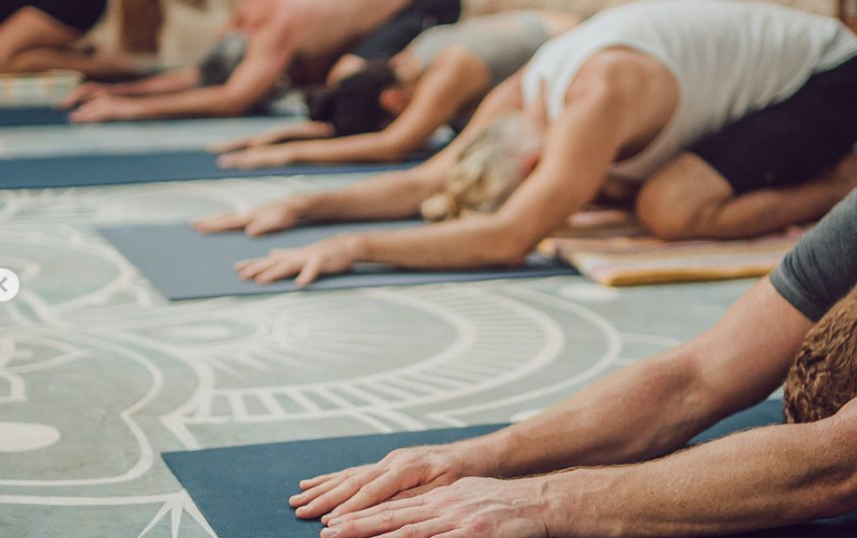 A bedroom with two beds and a sliding glass door.