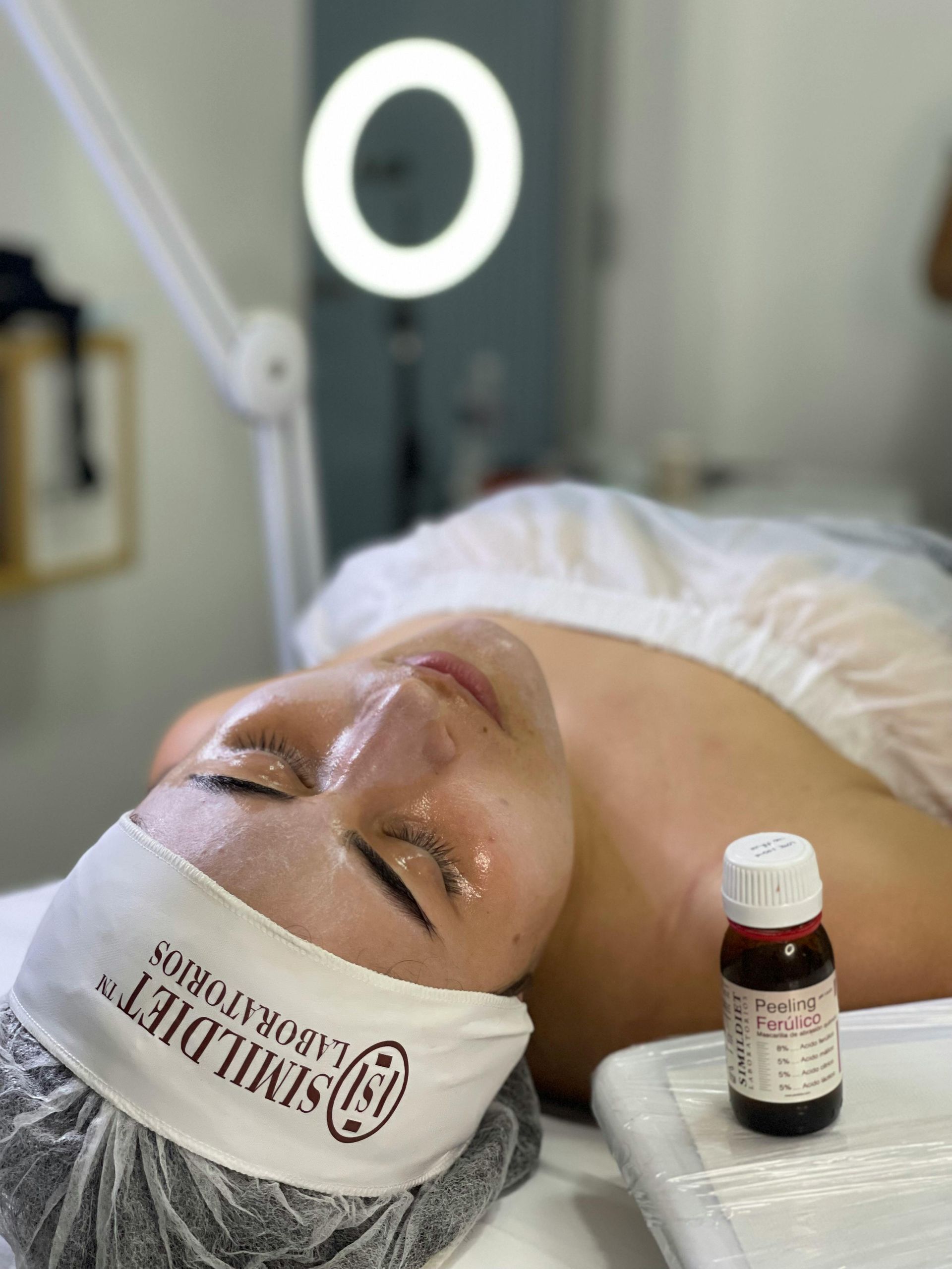 A woman is laying on a table with a headband on her head.