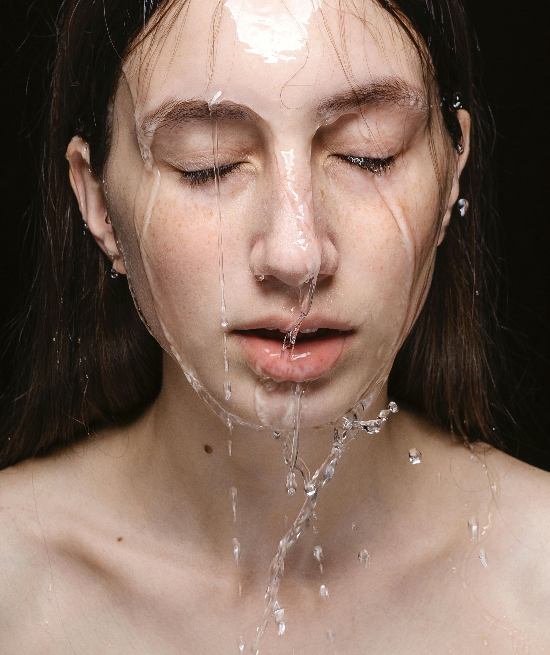 Woman with water running down her face