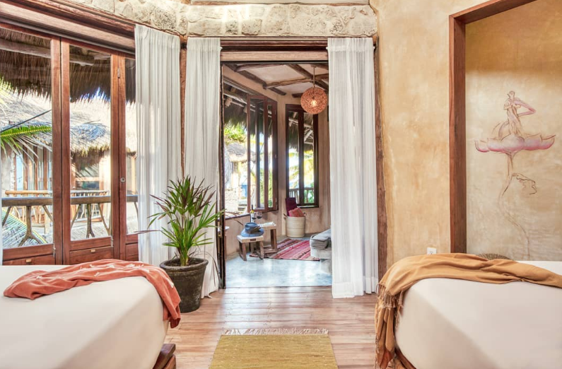 A group of people are sitting at a long table with plates of food