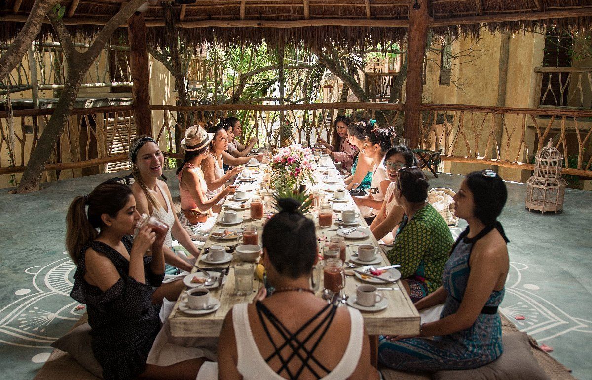 A long table with plates of food and drinks on it.
