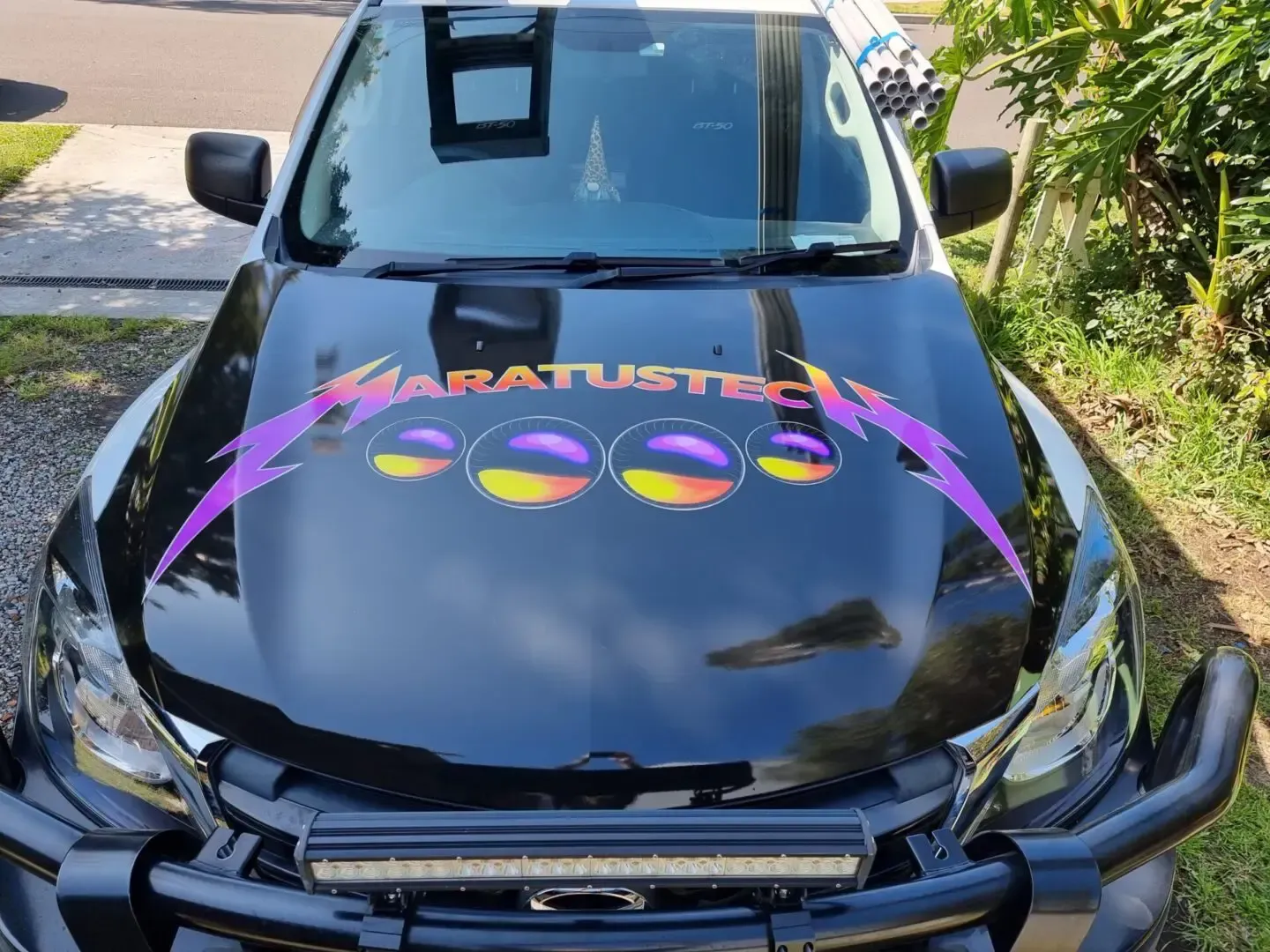 A Black Car With a Purple Logo on the Hood — Maratustech In Woy Woy, NSW