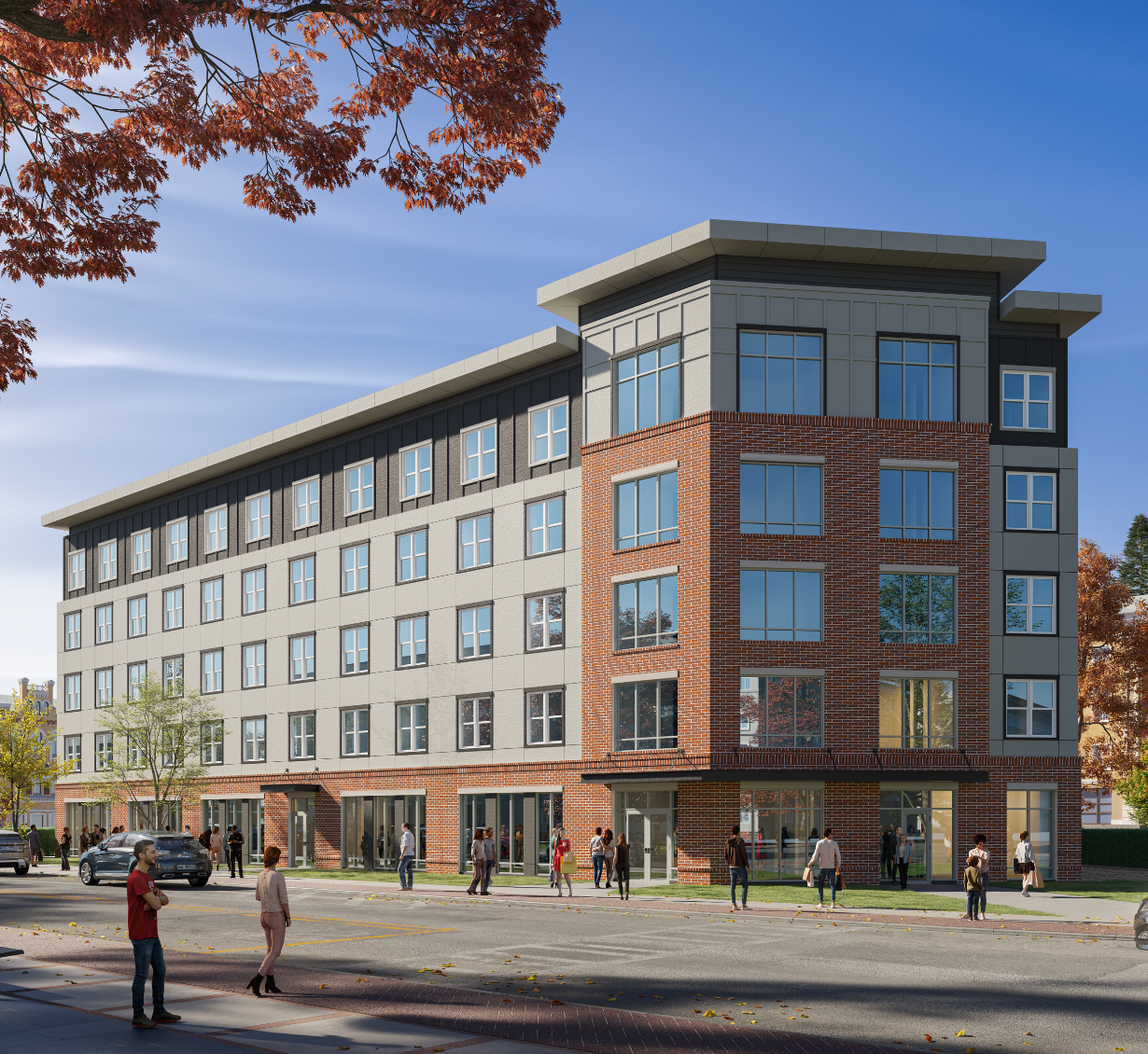 Aerial view of a complex with a large pool, lounge chairs, and an adjacent building with a dark roof.