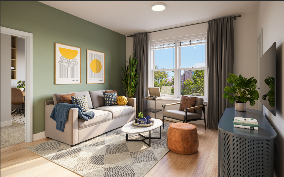 Plant in a black pot on a wooden shelf next to a gray built-in seating area.