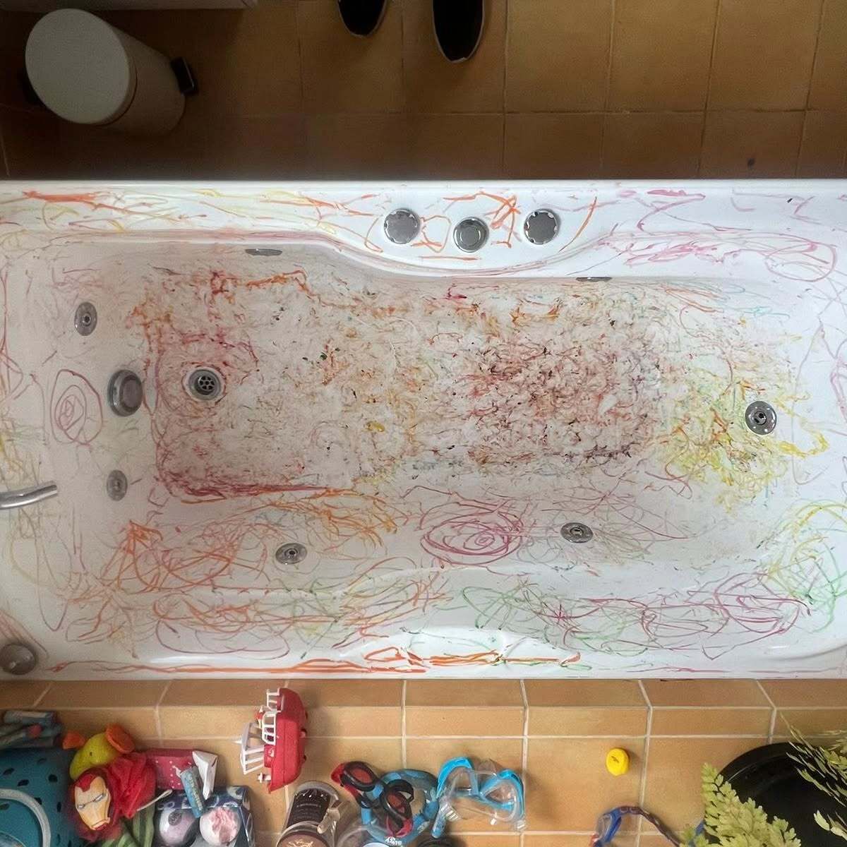A bathtub with a lot of colorful drawings on it.