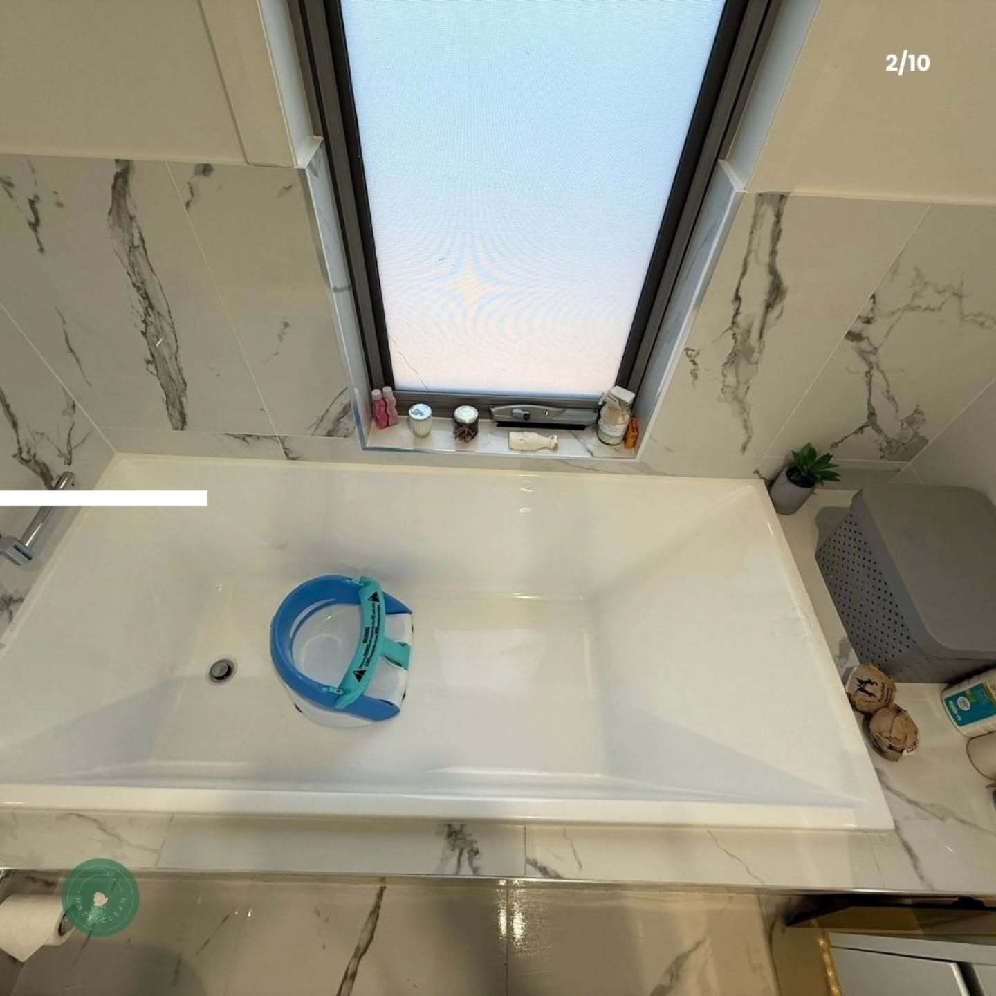 An aerial view of a bathroom with a bathtub and a window