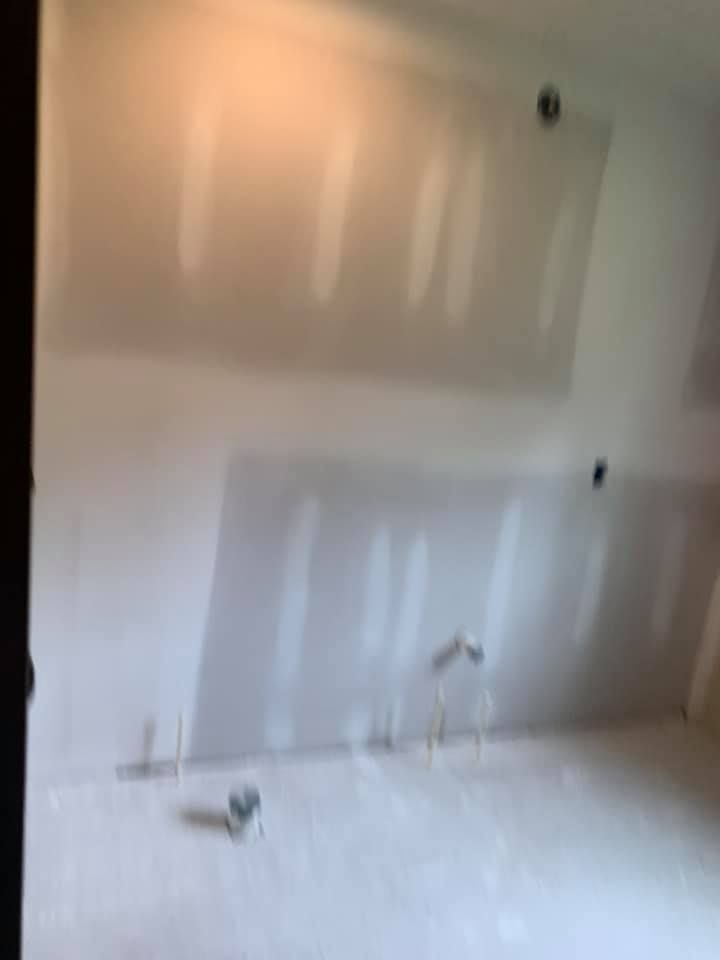 A room with a lot of drywall on the walls and ceiling.