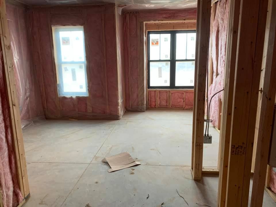 A room with a lot of insulation on the ceiling and a light on the ceiling.