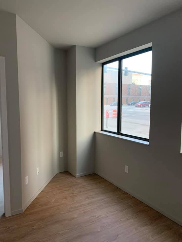 There is a large window in the corner of the room.