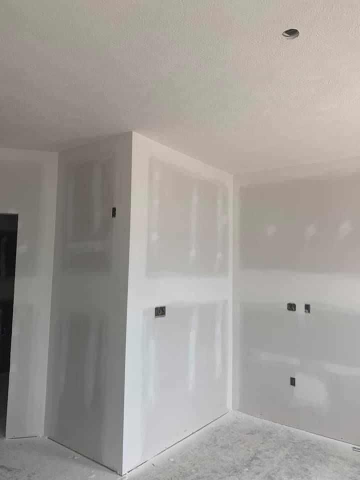 A room with white drywall walls and a ceiling.