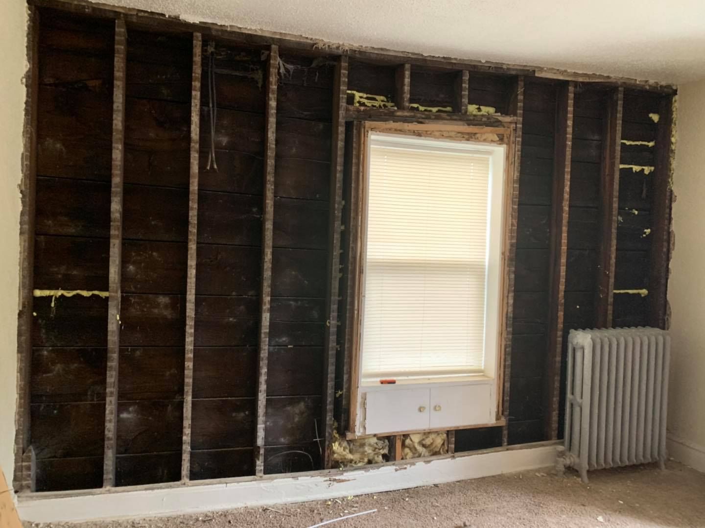 A room with a window and a radiator in it