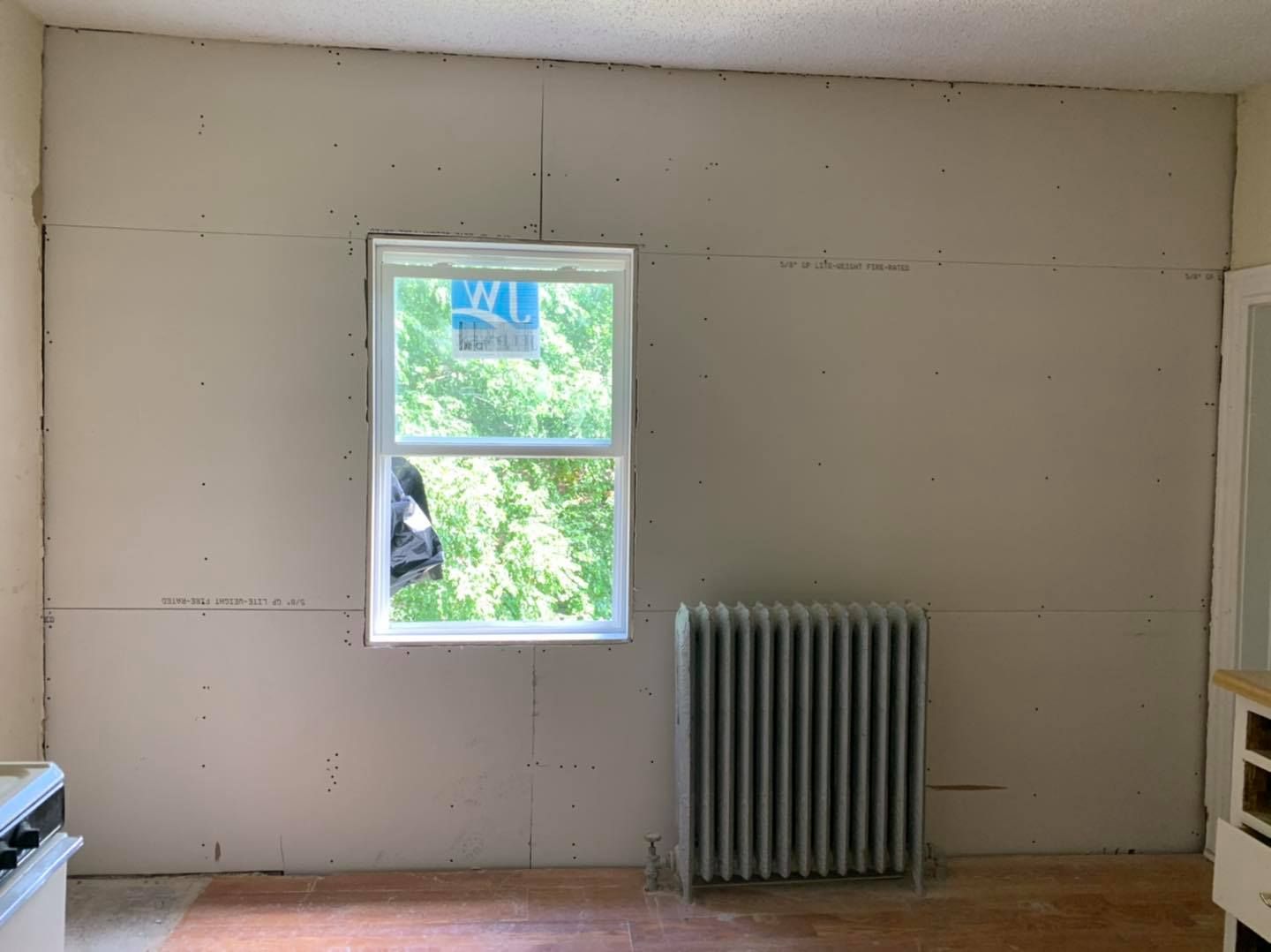 A room with a window and a radiator in it