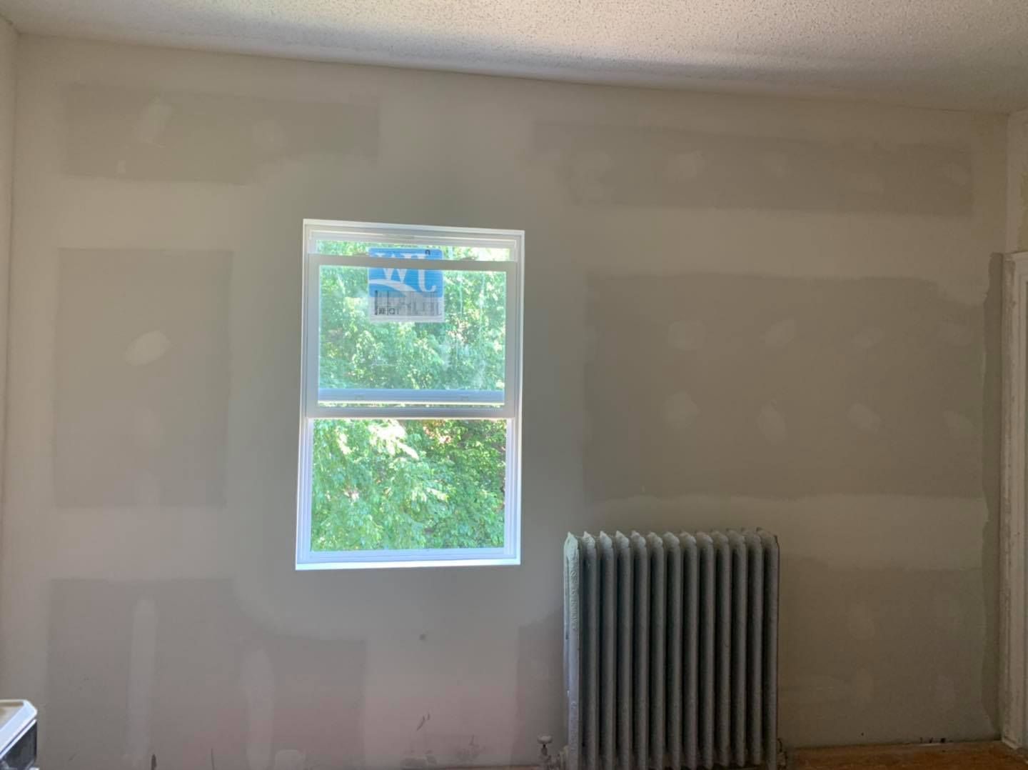 A room with a window and a radiator in it.