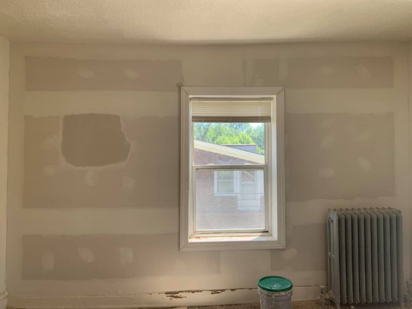 A room with a window and a radiator in it.